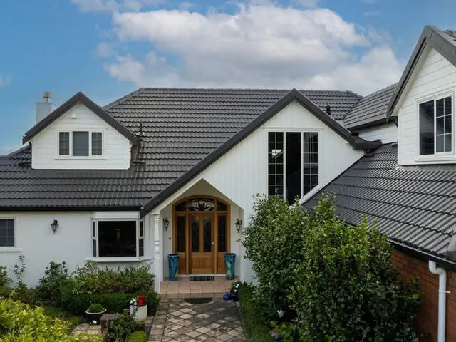 Restored tile roof on a Wellington home under a blue sky